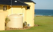cream white water tank near beach 13500 litres